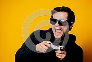 Man sunglasses keen plays with a joystick