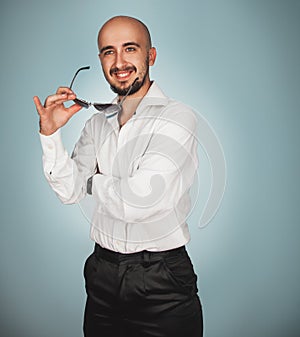 Man with sunglasses in studio smiling