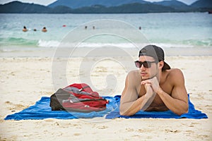 Man in sunglasses sunbathing