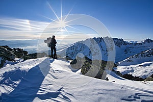 Man during sunset from Tupa peak in High Tatras during winter