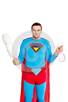 man in superhero costume holding duster and spray bottle