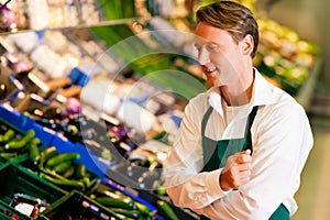 Man in supermarket as shop assistant