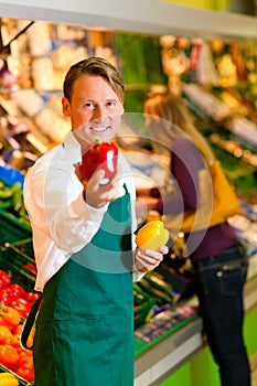 Man in supermarket as shop assistant