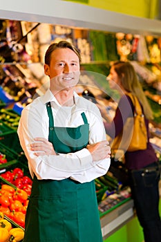 Man in supermarket as shop assistant