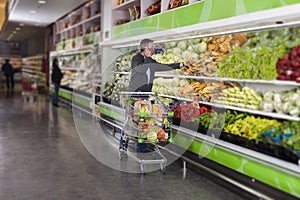 Man at supermarket and cellphone