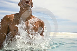 Man Surfacing In Swimming Pool photo