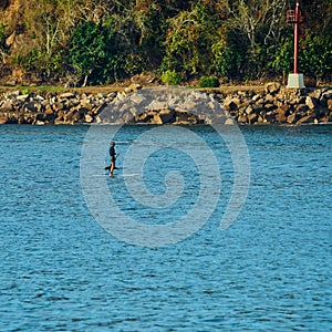 man on a surfboard in the middle of the sea waiting for a wave