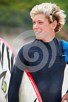 Man, surfer and face or happy outdoor with surfboard for adventure, vacation or holiday. Surfing, person and smile with