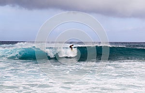 man surfing on the big wave