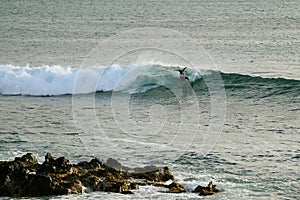 Man surfing on the big waves in Pacific Ocean at Hanga Roa, Easter Island, Chile