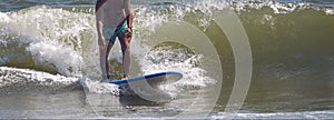 Man surfing on a blue and white surboard