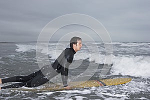 Man Surfing In Water At Beach
