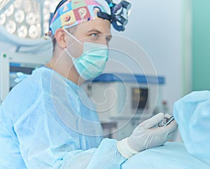 Man surgeon at work in operating room