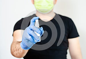Man with surgical gloves   and face   mask protecting himself from the transmission of diseases and covid-19 with  and  hand