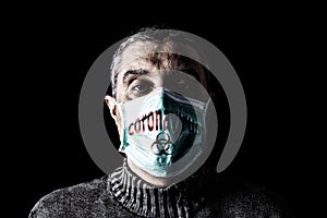 Man with surgical mask. Biohazard and Coronavirus, aka COVID-19 symbol. Pandemic or epidemic and scary, fear or danger concept.