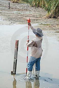 Man survey boundary of area