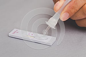 Man swab COVID-19 testing, Dropping saliva sample on the rapid antigen test kit. Coronavirus self nasal or home test, Lockdown and