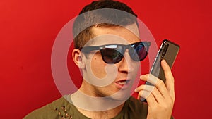 Man swears on phone isolated on red background