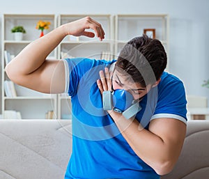 Man sweating excessively smelling bad at home