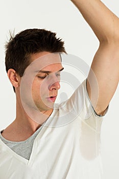 Man sweating very badly under armpit and looking t