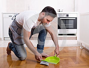 Man sweeping dust on parquet