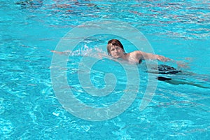 Man swim in blue swimming pool. Recreation