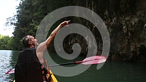 Man swim down the river on kayak