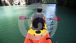 man swim down the river on kayak