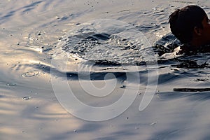Man swim's inside Yamuna river in Delhi India during morning time, Swimming inside Yamuna River