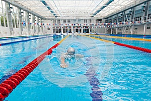 Man swimmer swimming crawl in blue water.