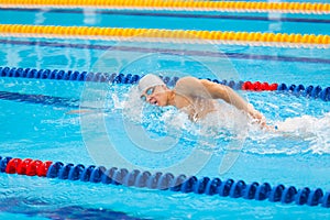 Man swimmer swimming crawl in blue water.