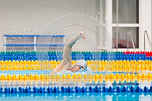 Man swimmer swimming crawl in blue water.