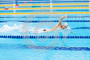 Man swimmer swimming crawl in blue water.