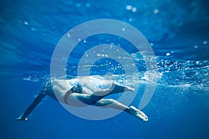 Man Swimming in the Deep Blue sea