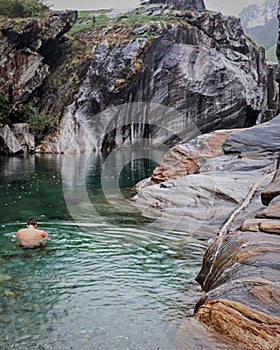 a man swimming in a mountain river