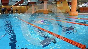 Man Swimming in Pool. Fit young male swimmer training in the pool. Young man swimming the front crawl in a pool. Young