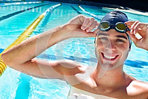 Man, swimming pool and happy in portrait for sport, workout and exercise for wellness, health and fitness. Swimmer