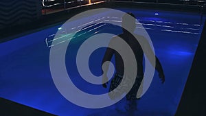 Man in the Swimming Pool at Night