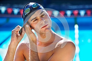 Man, swimming pool and ready with cap for sport with exercise for wellness, health or fitness with vision. Swimmer