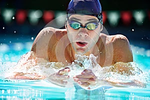 Man, swimming pool and training for sport with splash, speed and exercise for wellness, health and fitness. Swimmer