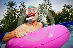 Man swimming in a portable swimming pool