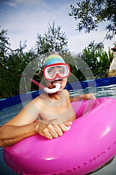 Man swimming in a portable swimming pool