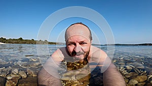 Man swimming in the sea with action camera