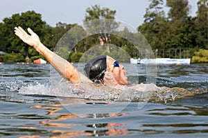 Man swims backstroke in a swimming pool photo