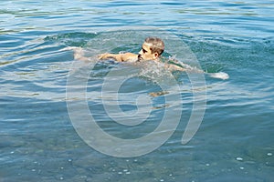 Man swims in the pond