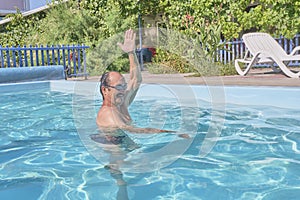 A man swims in a pool in the courtyard