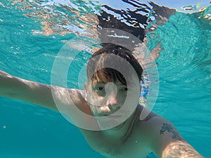 A man swims in the sea is engaged in diving