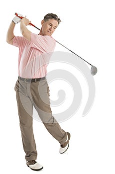 Man Swinging Golf Club Against White Background