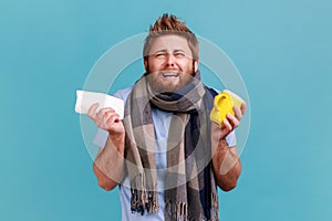 Man in T-shirt looking with displeased grimace crying, holding tea cup treating flu, cough and fever