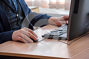 Man at the table in front of the computer